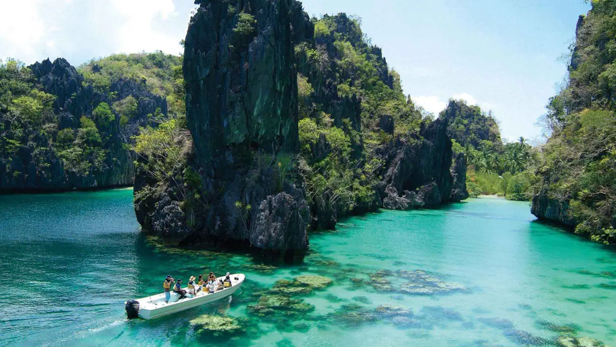 Shared bangka moored at the mouth of the Big Lagoon on an El Nido island hopping tour A, Miniloc Island, Palawan