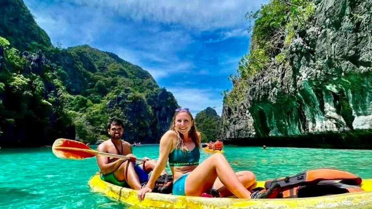 Kayaks entering the Big Lagoon between limestone walls on an El Nido island hopping tour A, Palawan, Philippines