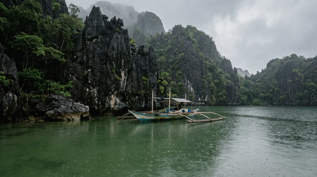 Rain clearing over limestone cliffs as a bangka crosses calm water on an El Nido island hopping tour, Bacuit Bay, Palawan